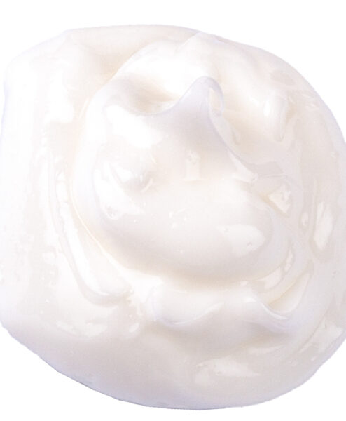 Round blob of white moisturizer on white background.
